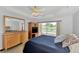 Bedroom features pool view, natural light, and neutral tones at 29 Tournament Rd, Rotonda West, FL 33947