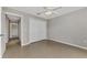 Bedroom featuring tile floors, ceiling fan, and closet with bi-fold doors at 29 Tournament Rd, Rotonda West, FL 33947
