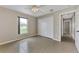 Bedroom featuring tile floors, a ceiling fan, and a closet with bi-fold doors at 29 Tournament Rd, Rotonda West, FL 33947