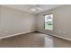 Bedroom featuring tile floors, a ceiling fan, and a window for natural light at 29 Tournament Rd, Rotonda West, FL 33947