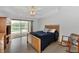 Relaxing bedroom with sliding glass doors to pool and lanai at 29 Tournament Rd, Rotonda West, FL 33947