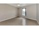 This bedroom features tile flooring, a ceiling fan, and a window for natural light at 29 Tournament Rd, Rotonda West, FL 33947