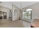 Bright dining room with arched entry, chandelier, and large arched window at 29 Tournament Rd, Rotonda West, FL 33947
