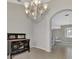 View of the dining room with an ornate black wood console table and tiled floors at 29 Tournament Rd, Rotonda West, FL 33947