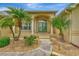 Elegant front entrance with a walkway and double doors, complemented by manicured landscaping and stone accents at 29 Tournament Rd, Rotonda West, FL 33947