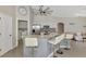 Open kitchen with stainless steel appliances, stone countertops, bar seating, and access to the laundry room at 29 Tournament Rd, Rotonda West, FL 33947