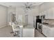 Kitchen with granite countertops, white cabinetry, stainless steel appliances, and bar seating at the island at 29 Tournament Rd, Rotonda West, FL 33947