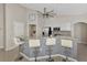 Kitchen features a breakfast bar with seating, granite countertops, stainless steel appliances, and white cabinets at 29 Tournament Rd, Rotonda West, FL 33947