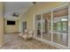 This home has a relaxing brick lanai featuring a ceiling fan and views of the pool at 29 Tournament Rd, Rotonda West, FL 33947