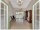 Spacious living room featuring tile flooring, high ceilings, and seamless access to the outdoor screened-in patio at 29 Tournament Rd, Rotonda West, FL 33947