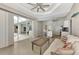 Open floor plan featuring a living room, kitchen, and a screened-in pool visible through sliding glass doors at 29 Tournament Rd, Rotonda West, FL 33947