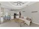 Living room with open concept design featuring a kitchen, tile floors, neutral walls, and modern ceiling fan at 29 Tournament Rd, Rotonda West, FL 33947