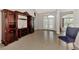 Open living area with tile floors, front doors, and a dark wood entertainment center at 29 Tournament Rd, Rotonda West, FL 33947