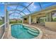 Screened-in pool with brick patio, steps leading into the water, and seating just outside the house at 29 Tournament Rd, Rotonda West, FL 33947