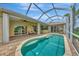 Screened-in pool features brick patio, tranquil outdoor living space, and direct access to the home's interior at 29 Tournament Rd, Rotonda West, FL 33947