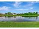 A tranquil waterway winds gently through the landscape, reflecting the sky and nearby houses at 29 Tournament Rd, Rotonda West, FL 33947