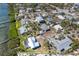 Serene aerial view of a waterfront community, with charming homes nestled amidst lush, tropical foliage at 4093 Pelican Shores Cir, Englewood, FL 34223