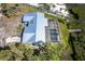 Aerial shot of a property featuring a screened pool, lush greenery, and a dock leading to the water at 4093 Pelican Shores Cir, Englewood, FL 34223