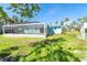 Spacious backyard with a pool enclosure and green grass providing ample space for outdoor activities at 4093 Pelican Shores Cir, Englewood, FL 34223