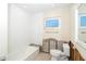 Clean white bathroom with updated subway tiles, toilet and a window for natural light at 4093 Pelican Shores Cir, Englewood, FL 34223