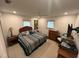 Cozy bedroom featuring a queen bed, tropical themed bedding, and natural light from 3 windows at 4093 Pelican Shores Cir, Englewood, FL 34223
