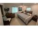 Bright bedroom featuring a queen bed, soft bedding, and natural light from the 2 windows at 4093 Pelican Shores Cir, Englewood, FL 34223