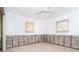 Spacious bedroom features neutral walls, carpet flooring, ceiling fan and two windows for ample natural light at 4093 Pelican Shores Cir, Englewood, FL 34223