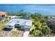 An exterior elevation shows a waterfront home with an aluminum roof, screened lanai, and dock access to the water at 4093 Pelican Shores Cir, Englewood, FL 34223