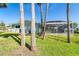 Charming home with a screened pool enclosure, surrounded by palm trees and a lush lawn at 4093 Pelican Shores Cir, Englewood, FL 34223