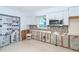 Kitchen with white cabinets, mosaic tile backsplash, and in need of repair from previous flooding damage at 4093 Pelican Shores Cir, Englewood, FL 34223