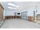 Spacious living room with white walls, sky lights, and in need of repair from previous flooding at 4093 Pelican Shores Cir, Englewood, FL 34223