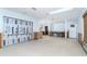 Open concept living room with white walls and tile flooring with view to kitchen. Home in need of repair at 4093 Pelican Shores Cir, Englewood, FL 34223