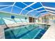 Inviting screened pool with brick trim in a well-maintained backyard offers a relaxing outdoor oasis at 4093 Pelican Shores Cir, Englewood, FL 34223