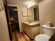 A full bathroom features tile floors and a modern vanity with a sink, mirror, and toilet at 4260 Placida Rd # 21C, Englewood, FL 34224