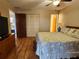 Bedroom featuring laminate floors and a spacious closet at 4260 Placida Rd # 21C, Englewood, FL 34224
