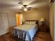 Comfortable bedroom featuring laminate floors and a ceiling fan at 4260 Placida Rd # 21C, Englewood, FL 34224