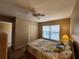A bright bedroom has a window, ceiling fan, and closet at 4260 Placida Rd # 21C, Englewood, FL 34224