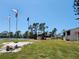 Landscaped common area with mature trees and community tennis courts at 4260 Placida Rd # 21C, Englewood, FL 34224