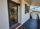 Front door view from balcony, with decorative door, tile landing, and black shutters at 4260 Placida Rd # 21C, Englewood, FL 34224