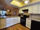 Updated kitchen features white cabinets, black appliances, and granite countertops, open to the living area at 4260 Placida Rd # 21C, Englewood, FL 34224