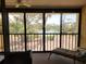 Relaxing lanai with comfortable seating and a view of the landscaped yard and tennis court at 4260 Placida Rd # 21C, Englewood, FL 34224