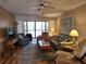 Bright living room featuring comfortable seating, a ceiling fan, and access to the lanai at 4260 Placida Rd # 21C, Englewood, FL 34224