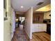 Hallway with kitchen on right and living room with sliding door in the background at 4260 Placida Rd # 21C, Englewood, FL 34224