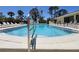 Community pool with in-water steps and several lounge chairs surrounding pool at 4260 Placida Rd # 21C, Englewood, FL 34224