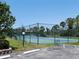 Outdoor tennis court featuring new green surface and black chain-link fence at 4260 Placida Rd # 21C, Englewood, FL 34224