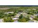 Wide aerial view of property surrounded by lush greenery and tropical trees at 5250 Callaway St, Port Charlotte, FL 33981