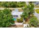 Aerial view of pool area with a screen enclosure and mature trees at 5250 Callaway St, Port Charlotte, FL 33981