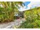 Lush backyard garden with mature trees and tranquil seating area, perfect for relaxing at 5250 Callaway St, Port Charlotte, FL 33981