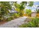 Inviting backyard featuring lush tropical landscaping, a pool enclosure, and a convenient storage shed at 5250 Callaway St, Port Charlotte, FL 33981