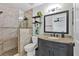 Updated bathroom boasts a tiled walk-in shower, modern vanity, and stylish decor at 5250 Callaway St, Port Charlotte, FL 33981